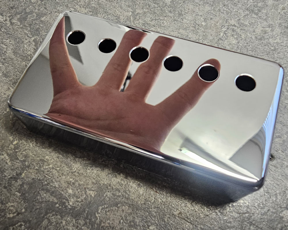 Chrome Humbucker Cover with reflection of hand