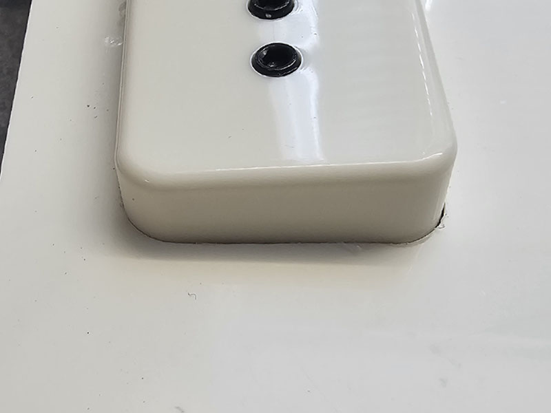 A close up of the Radius match on an Epiphone P90 cover and the pickguard route