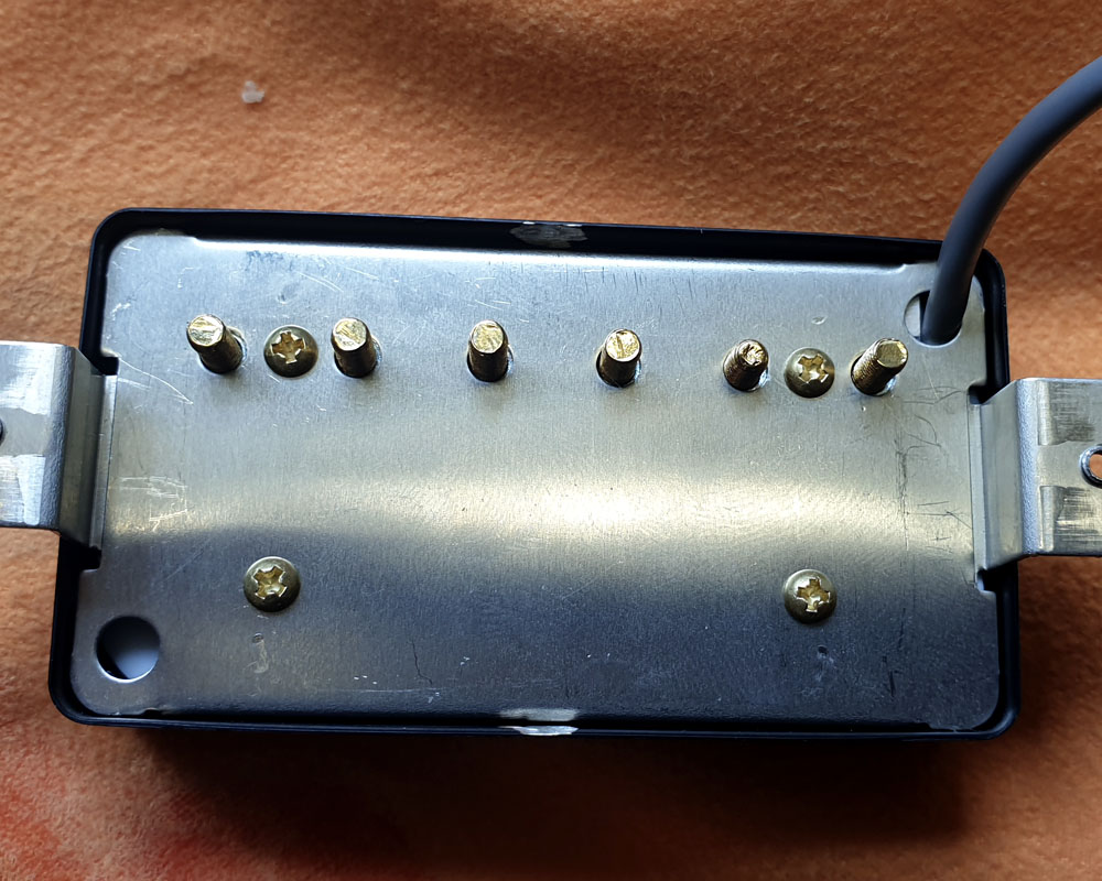 Black cover fitted to humbucker with gold poles