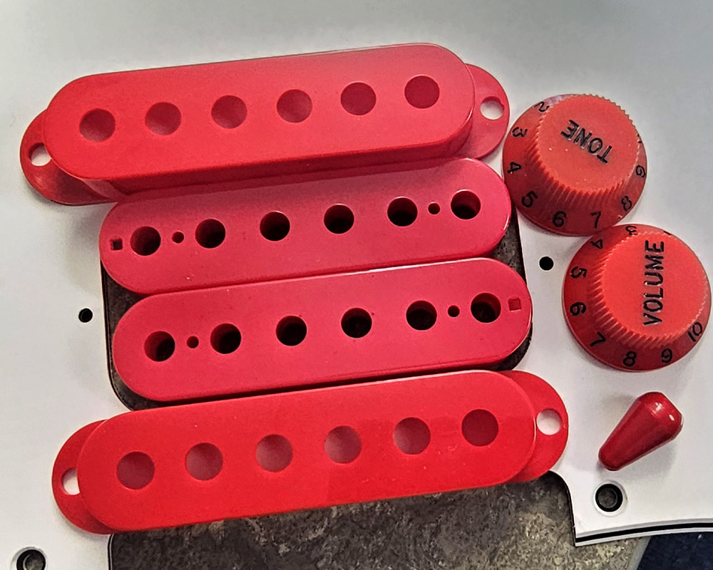 REd Plastic pickup parts and knobs side by side comparison